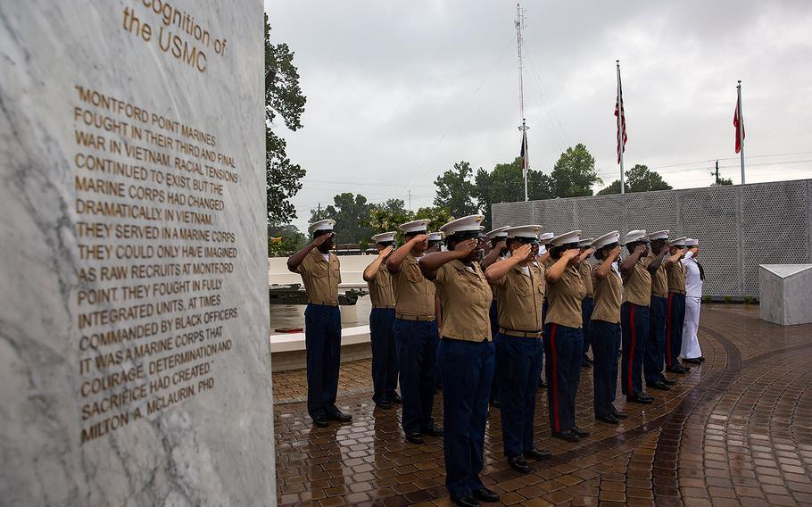 Marines with 2nd Supply Battalion, 2nd Marine Logistics Group, salute during the Montford Point Marine Memorial gifting ceremony at the Montford Point Marine Memorial in Jacksonville, N.C., July 25, 2018. 