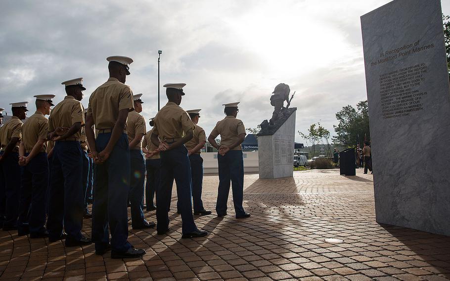 Marines with 2nd Supply Battalion, 2nd Marine Logistics Group, stand in formation during the Montford Point Marine Memorial gifting ceremony at the Montford Point Marine Memorial in Jacksonville, N.C., July 25, 2018. 
