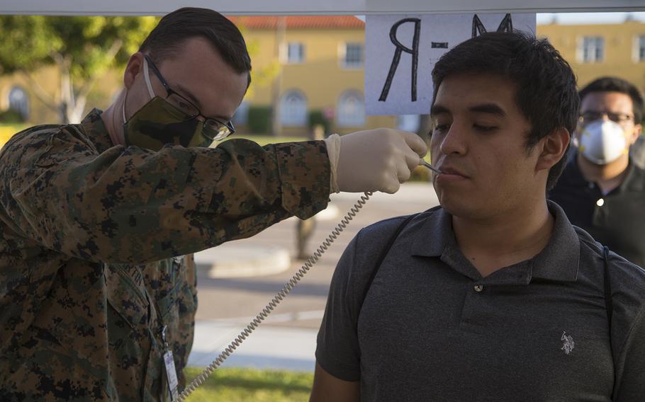 A new recruit with India Company, 3rd Recruit training Battalion, is medically screened after arriving at Marine Corps Recruit Depot, San Diego, April 27, 2020.