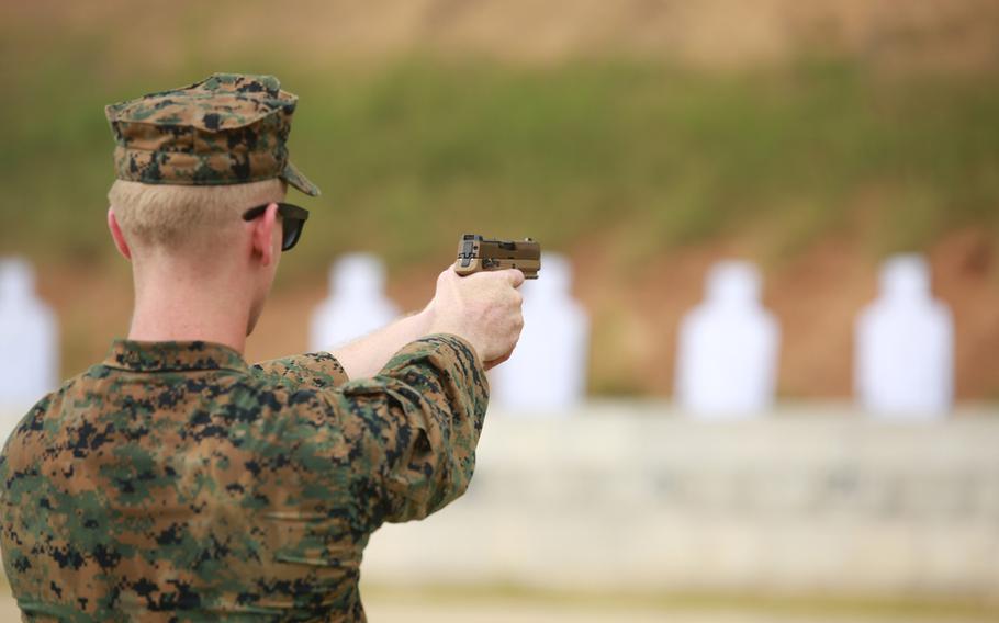 A Marine instructor shoots the M18 handgun at a firing range during training June 25, 2020, at Marine Corps Base Quantico, Va.