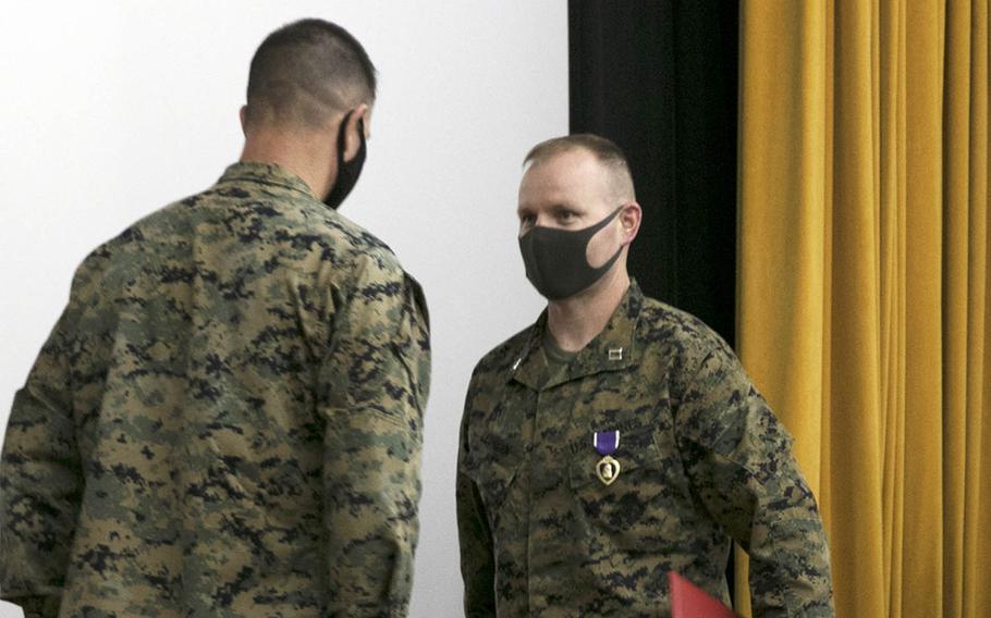 Marine Capt. Kevin Leishman receives a Purple Heart from Brig. Gen. Kyle Ellison, commander of the 3rd Marine Expeditionary Brigade, at Camp Courtney, Okinawa, Wednesday, Feb. 24, 2021.