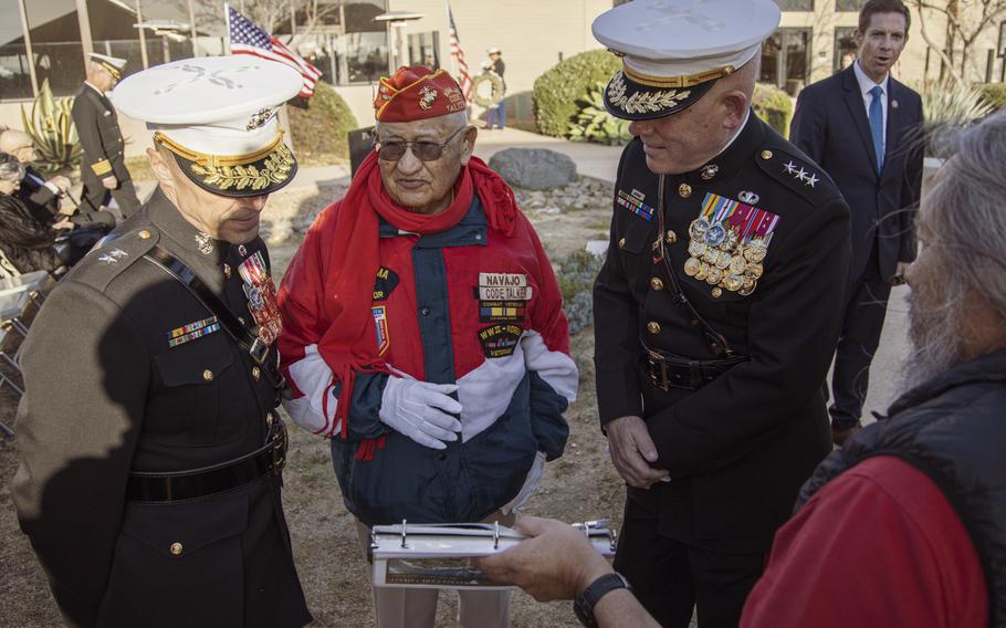 Thomas H. Begay, center, a Navajo Code Talker and Iwo Jima veteran, shows his scrapbook of photos from his time as a Marine to 1st Marine Division commander Maj. Gen. Robert F. Castellvi, left, and I Marine Expeditionary Force commander Lt. Gen. Joseph L. Osterman, right, at a sunset ceremony marking the 75th anniversary of the Battle of Iwo Jima at Marine Corps Base Camp Pendleton, Calif., on Saturday, Feb. 15, 2020.
