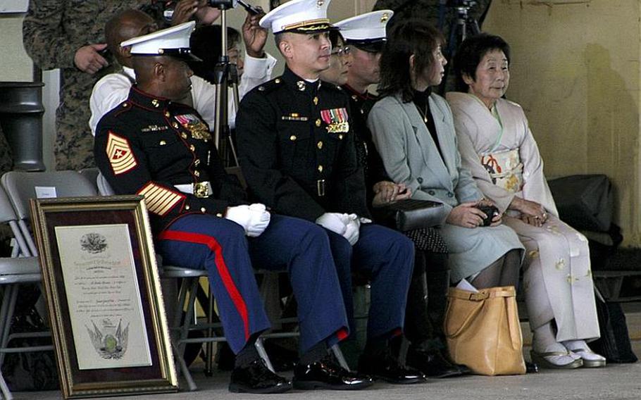 Sgt. Maj. Gerard Calvin, Marine Aviation Logistics Squadron 12 sergeant major, and Lt. Col. Charles Redden, MALS-12 commanding officer, sits with Machiko Hamamoto (far right), Honorary Marine recipient, during a ceremony Tuesday at the Strike Fighter Squadron 94 hangar at Marine Corps Air Station Iwakuni. Hamamoto has worked with MALS-12 for 43 years, providing the squadron opportunities to interact with the local Japanese population.

