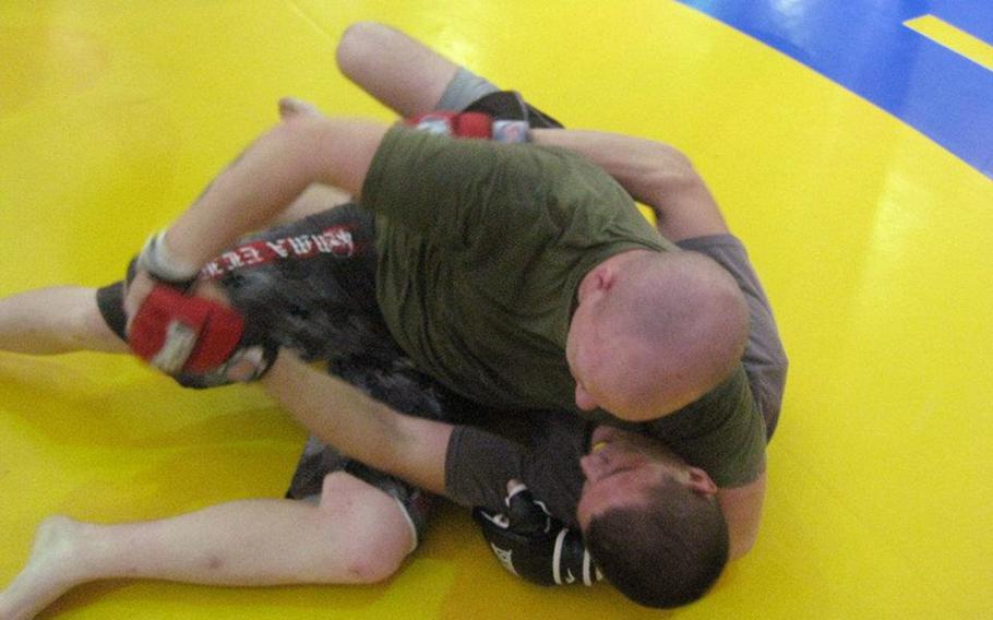 Military Alliance Fight Team members grapple at Gunner&#39;s Gym on Okinawa during a recent training session. The Marines have enacted more stringent guidelines on who can participate in mixed martial arts events off-duty as a way to ensure the safety of Marines and sailors.