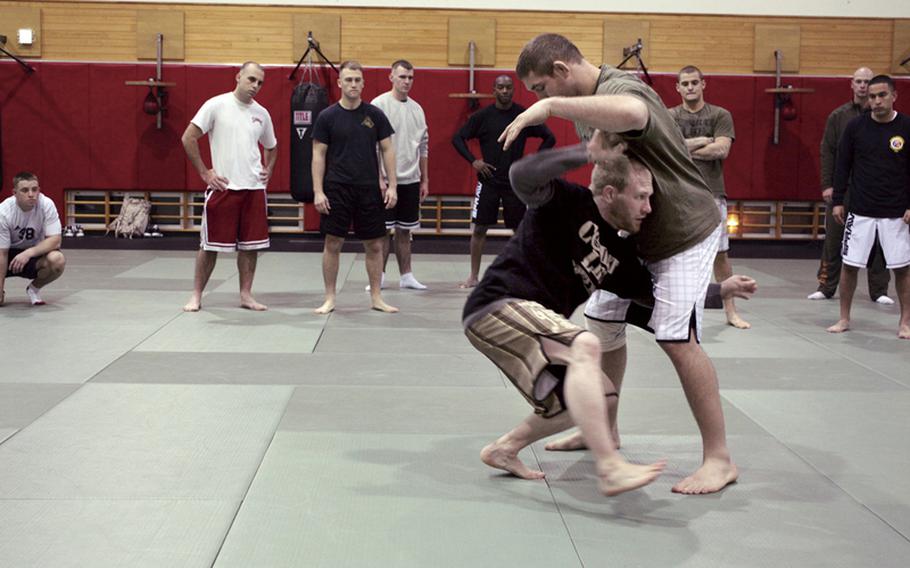 Marines on Camp Hansen practice techniques taught by professional mixed martial arts fighters, a part of the MMA Fighters to Fighters tour, sponsored by Armed Forces Entertainment and Marine Corps Community Services on Jan. 14, 2011. Marine Corps officials in the Pacific have issued a new policy aimed at reducing injuries.