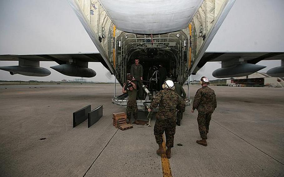 Marines load a KC-130J Hercules aircraft at Marine Corps Air Station Futenma bound for the Republic of the Philippines on Dec. 8, 2012, to assist in humanitarian assistance and disaster relief efforts in the wake of Typhoon Bopha.