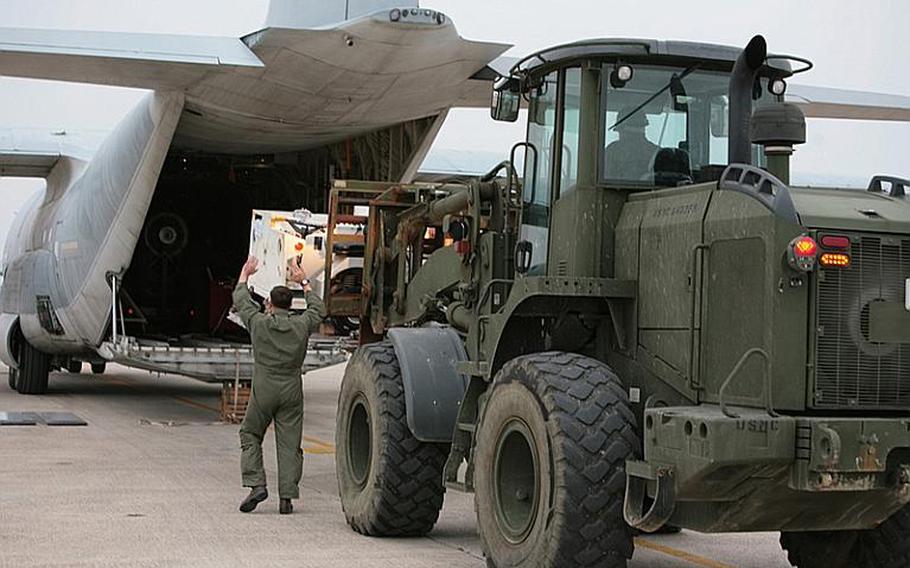 Marines load a KC-130J Hercules aircraft at Marine Corps Air Station Futenma bound for the Republic of the Philippines to assist in humanitarian assistance and disaster relief efforts in the wake of Typhoon Bopha. The aircraft provides the lift capacity and capability to transport personnel and relief supplies to areas where they are needed.