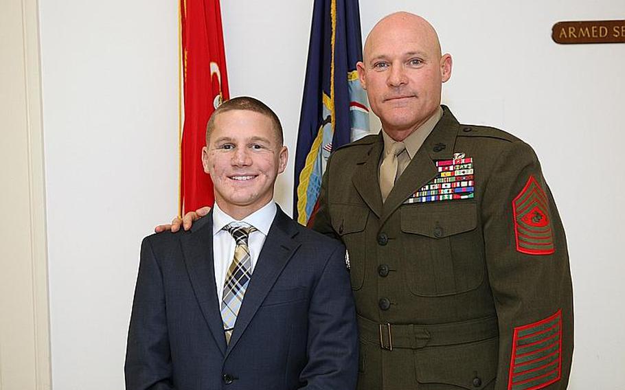 Cpl. William Kyle Carpenter stands beside Sgt. Maj. Micheal P. Barrett, the 17th Sergeant Major of the Marine Corps, in Washington, D.C., on Jan. 23, 2013.