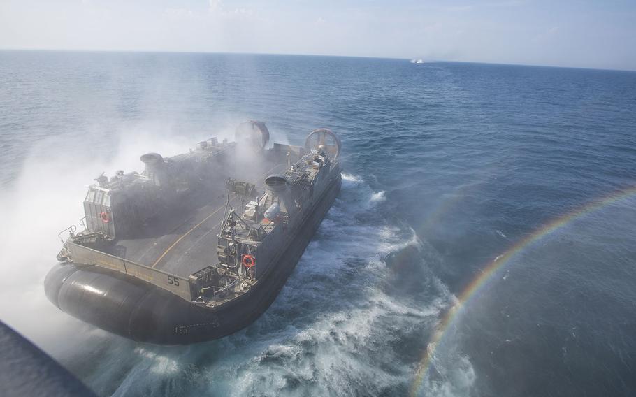 A U.S. Navy Landing Craft Air Cushion assigned to Amphibious Squadron 4  Amphibious Squadron exits the well deck of the USS Kearsarge, after dropping off personnel and equipment during Amphibious Ready Group/Marine Expeditionary Unit Exercise in the Atlantic Ocean, on June 15, 2015.