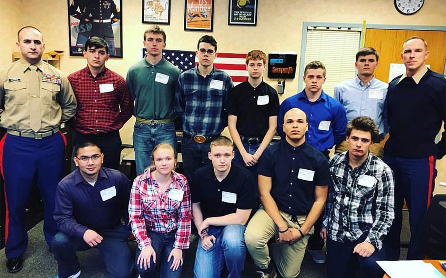 Maj. Brandon Currie, left, and Sgt. Maj. Christopher Lillie, right, with Marine recruits before they headed off to boot camp. Currie and Lillie have been fired from Recruiting Station Cleveland for not fulfilling their recruiting mission, a spokesman for the Marine Corps said Friday.