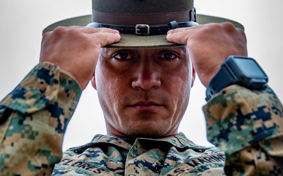 Marine Corps Staff Sgt. Edwin Flores, a drill instructor with Company K, 3rd Recruit Training Battalion, adjusts his campaign cover at Marine Corps Base Camp Pendleton, Calif., in 2018. The Corps has put out a casting call for active duty and reserve Marines to participate in the service's latest recruiting campaign.