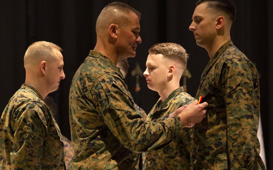 Maj. Gen. Karsten Heckl, second from left, commanding general, 2nd Marine Aircraft Wing, presents Cpl. Timothy Watson with the Navy and Marine Corps Medal at Marine Corps Air Station Cherry Point, N.C., January 28, 2020. Watson along with Staff Sgt. Leary Reichartwarfel, Sgt. Anders Larson and Cpl. Austin McMullen received the award for saving a family at Atlantic Beach, N.C., in 2018.
