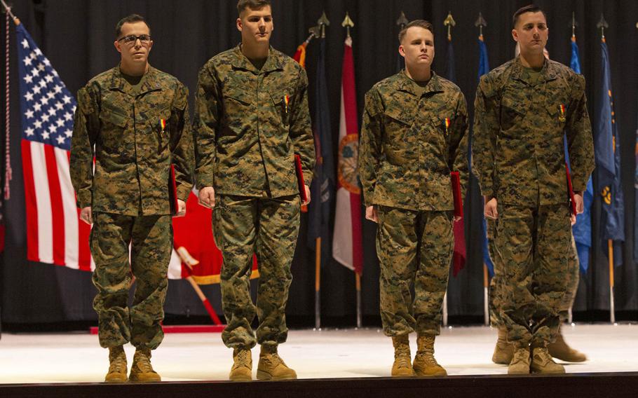 Staff Sgt. Leary Reichartwarfel, Sgt. Anders Larson, Cpl. Austin McMullen and Cpl. Timothy Watson pose for a photo after receiving the Navy and Marine Corps Medal at Marine Corps Air Station Cherry Point, N.C., January 28, 2020.