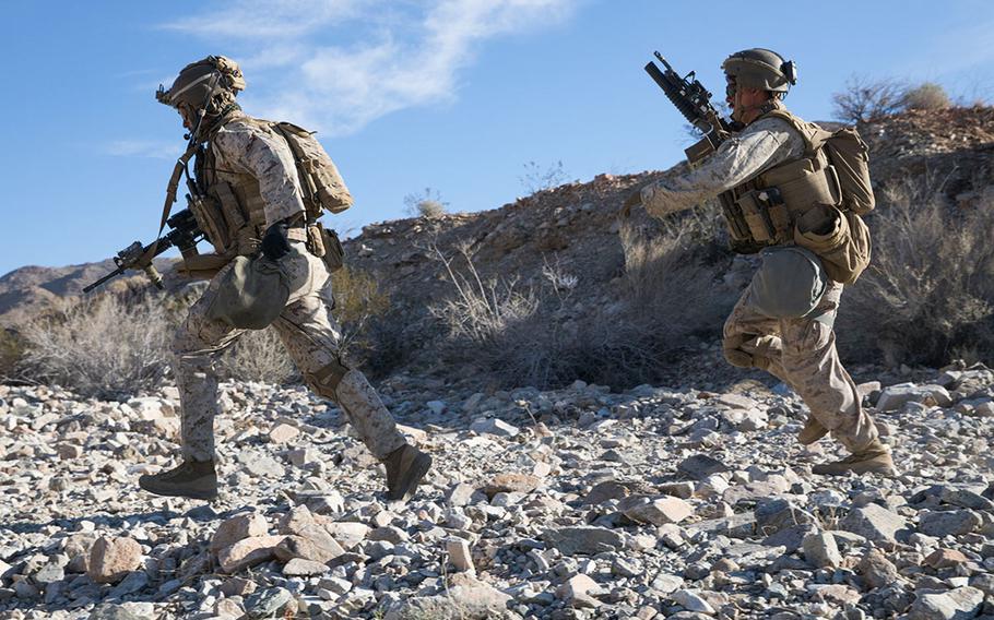 Sgt. Robert Peas, left, and Lance Cpl. Cameron O'Hara, infantry Marines with 2nd Battalion, 5th Marine Regiment, 1st Marine Division, sprint to cover during the Integrated Training Exercise at Marine Air Ground Combat Center Twentynine Palms, Calif., Jan. 25, 2020. The U.S. Marine Corps started issuing more streamlined body armor that provides a better fit and is significantly lighter than the current model.