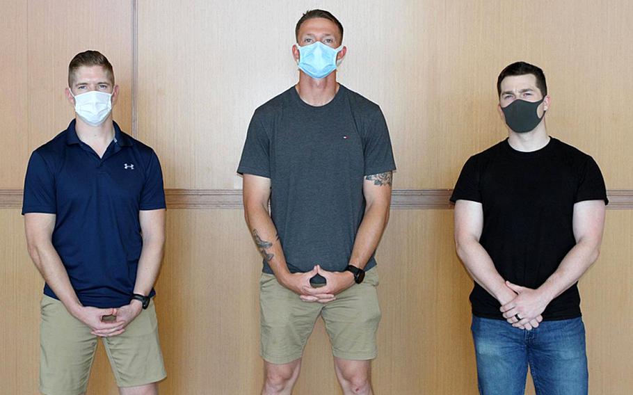 From left, Capt. Daniel Kult, Sgt. John Dietrick and Pfc. Alexander Meinhardt, of 1st Battalion, 6th Marine Regiment, 2nd Marine Division, II Marine Expeditionary Force, pose at Dallas/Fort Worth International Airport, May 4, 2020. The three Marines detained a hostile passenger during a flight from Japan to Texas, a service statement said.