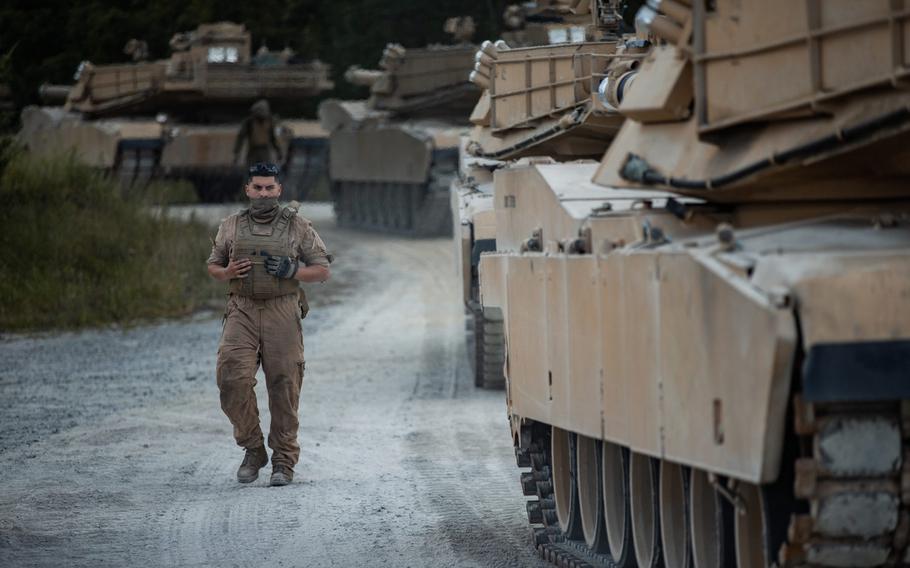 A U.S. Marine with 2nd Tank Battalion, 2nd Marine Division ground guides M1A1 Abrams tanks through a tank trail on Camp Lejeune, N.C., July 27, 2020. After serving 2nd MARDIV for more than three-quarters of a century, 2nd Tank Battalion will deactivate as part of the Marine Corps' modernization plan.