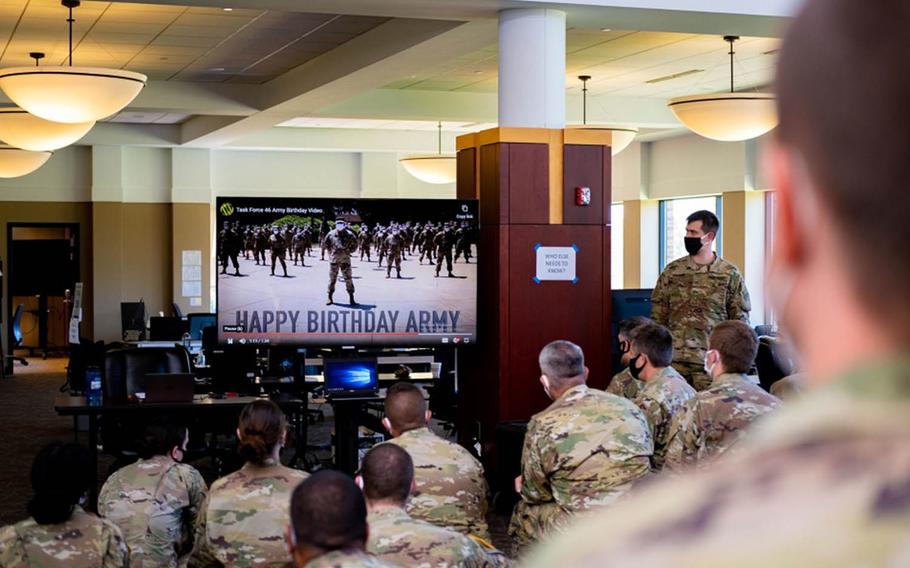 Soldiers in East Lansing, Mich., watch a video celebrating the Army's 245th birthday this year in lieu of the traditional large gatherings.