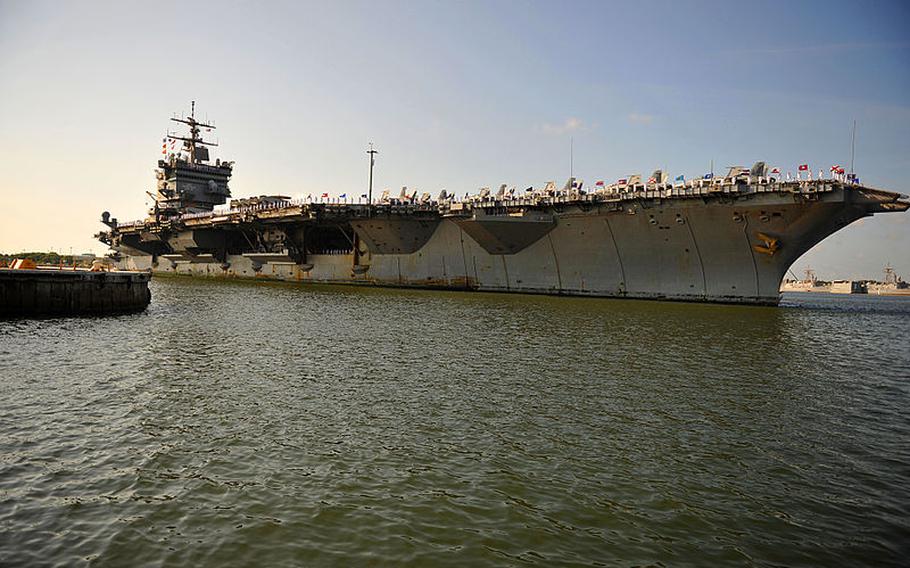 The aircraft carrier USS Enterprise approaches the pier at Naval Station Mayport, Fla., in July 2011. The Navy says that vessels from Naval Submarine Base Kings Bay and Naval Station Mayport already take precautions to ensure there are no collisions with right whales when they are in area waters during calving season.