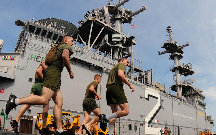 Marines assigned to the 31st Marine Expeditionary Unit run on the flight deck of the forward-deployed amphibious assault ship USS Essex (LHD 2) in 2010.