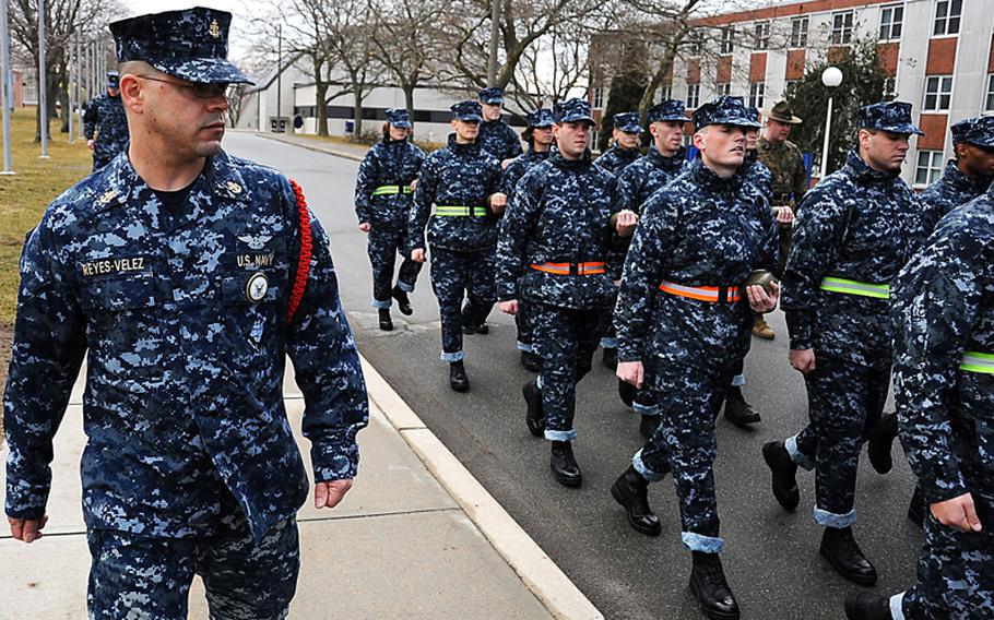 Chief Petty Officer Jorge Reyes-Velez, a recruit division commander at Officer Training Command, marches with officer candidates from Officer Candidate School at Naval Station Newport.