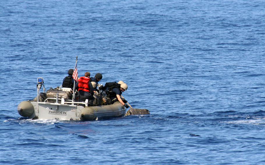 Sailors in a rigid hull inflatable boat from the guided-missile cruiser USS Princeton retrieve what turned out to be a bale of marijuana in the Pacific Ocean off California on June 16, 2012. Three vessels dumped 18,600 pounds worth of marijuana after being spotted by the USS Nimitz, which was conducting carrier flight qualifications at the time.