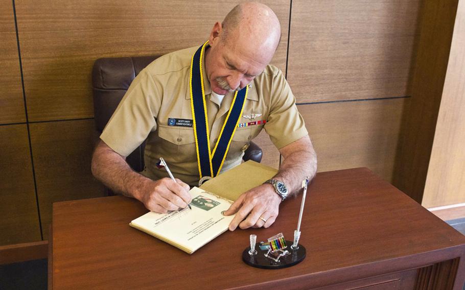 Vice Adm. Scott Swift, commander of U.S. 7th Fleet, signs a guestbook at the Philippine navy headquarters on Naval Station Jose V Andrada in Manila in this March 2012 photo.
