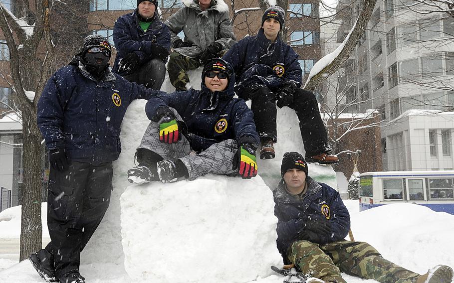 The 2013 Misawa snow team from left, Airman Gabriel Neri, Petty Officer 3rd Class Shawn Mullen, Chief Billy Knox, Petty Officer 2nd Class Parnell Nauta, Petty Officer 2nd Class Ryan Miller, and Petty Officer 2nd Class Ismael Ponce. The team is from Naval Air Facility Misawa and created a snow sculpture on behalf of the base for the city's annual festival on northern Japan's Hokkaido Island. This is the 30th year that the naval installation has sent a delegation of sailors to take part in the city's festival. They created a scaled-down replica of USS George Washington's forecastle out of snow and ice.