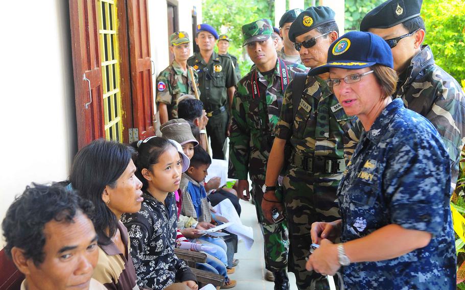 In this file photo from 2010, Capt. Lisa M. Franchetti speaks with medical patients at a medical civic action program in Rattanakiri, Cambodia, in support of Pacific Partnership 2010. 
