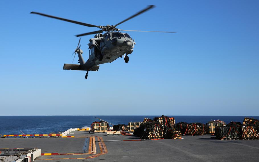 An MH-60S Knighthawk approaches USS Kearsarge (LHD 3) during a replenishment-at-sea in this Jan. 2013 photo. 