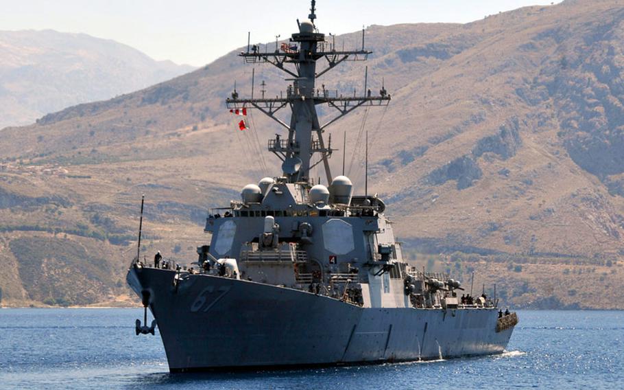 The guided missile destroyer USS Cole conducts a berth shift during a port visit on the Greek island of Crete in June 2012.