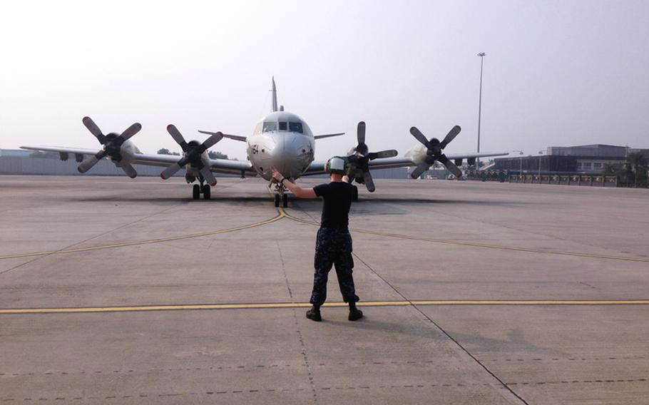 A U.S. Navy P-3C Orion prepares to depart in search of the missing Malaysian Airlines flight MH370 in the Gulf of Thailand. The flight had 227 passengers from 14 nations, mainly China, and 12 crew members. According to the Malaysia Airlines website, three Americans, including one infant, were also aboard.