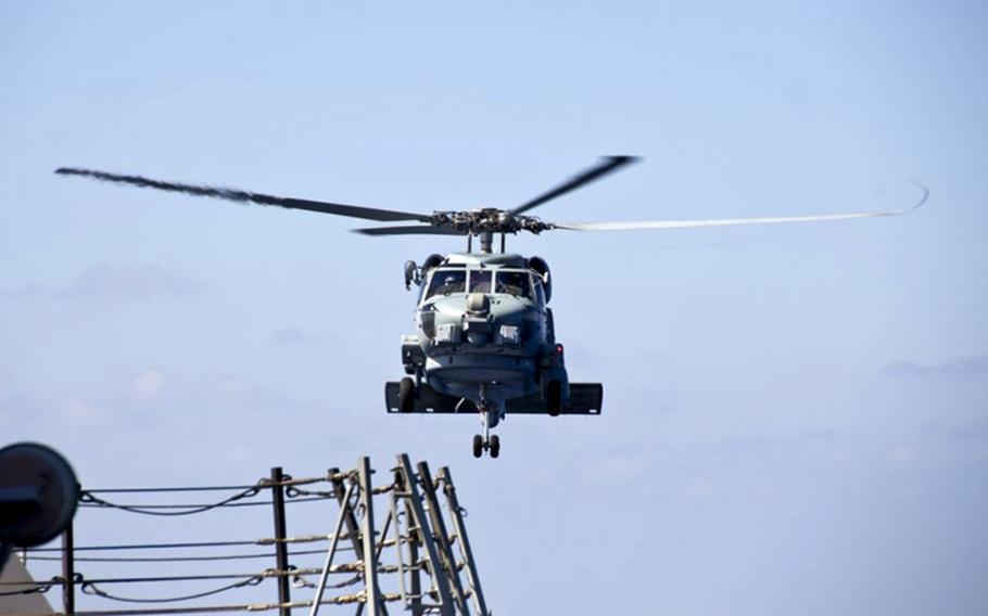 A U.S. Navy MH-60R Sea Hawk helicopter from the Arleigh Burke-class destroyer USS Pinckney (DDG 91) departs to aid in the search efforts of the missing Malaysia Airlines flight MH370. The flight had 227 passengers from 14 nations, mainly China, and 12 crew members. According to the Malaysia Airlines website, three Americans, including one infant, were also aboard. 