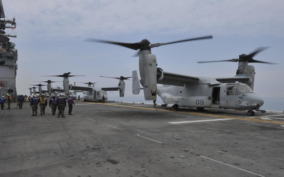MV-22 Osprey tiltrotor aircrafts, assigned to Marine Medium Tiltrotor Squadron (VMM) (Reinforced) 265, stand ready on the flight deck of the forward-deployed amphibious assault ship USS Bonhomme Richard (LHD 6) April 16, 2014.