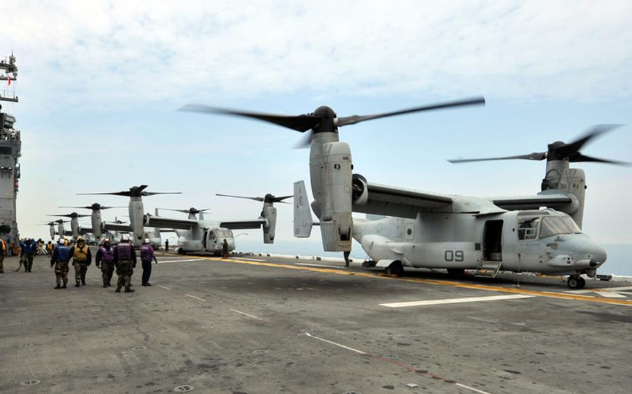 MV-22 Osprey tilt-rotor aircraft stand ready Wednesday, April 16, 2014, on the flight deck of the amphibious assault ship USS Bonhomme Richard, which is responding to the scene of the South Korean passenger ship Sewol that sank that day off the southwestern coast of the Republic of Korea.
