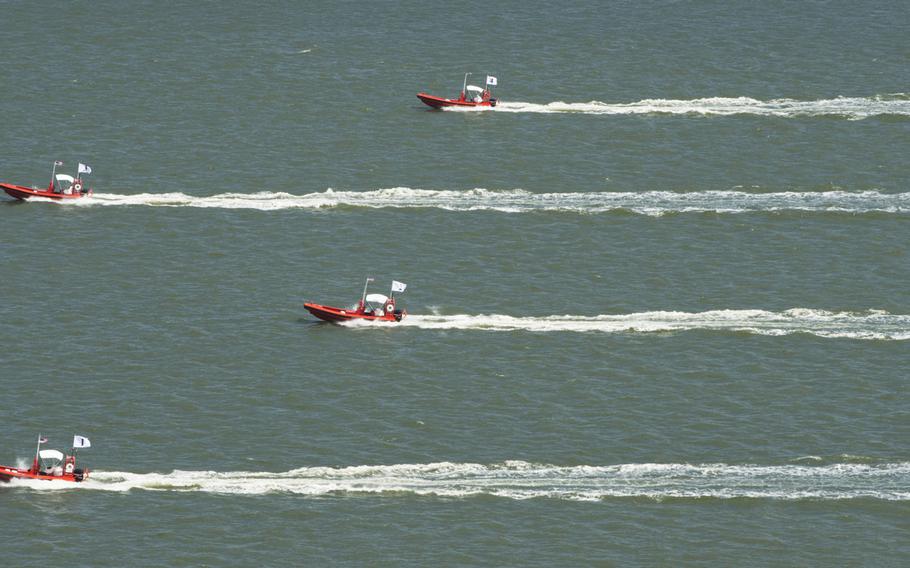 This Tuesday Aug. 12, 2014 photo provided by the U.S. Navy shows an Four unmanned remotely operated high-speed maneuvering surface targets as they  move to their blocking positions during an Office of Naval Research demonstration of autonomous swarmboat technology  on the James River in Newport News, Va.