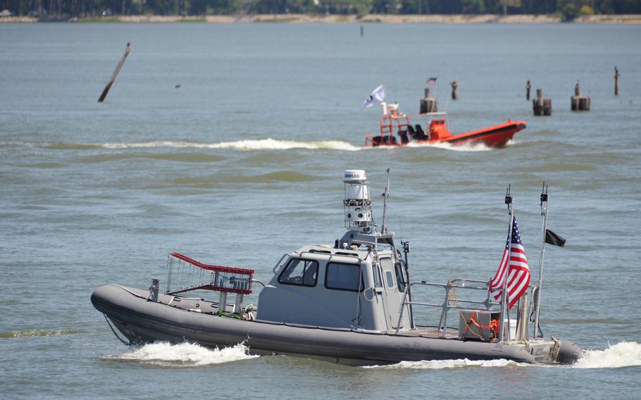 This Tuesday Aug. 12, 2014 photo provided by the U.S. Navy shows an unmanned 11-meter rigid hulled inflatable boat (RHIB) from Naval Surface Warfare Center Carderock, as it operates autonomously during an Office of Naval Research demonstration of swarmboat technology held on the James River in Newport News, Va.