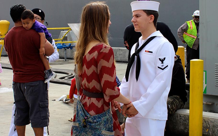 Petty Officer 3rd Class Jesse Charpentier says goodbye to his wife, Ashley, at Naval Base San Diego on Friday, Oct. 31, 2014, before boarding the USS Sampson for his 1st deployment.