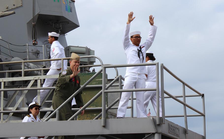 Sailors wave goodbye to their families as they board the USS Sampson on Friday, Oct. 31, 2014, at Naval Base San Diego. The ship is deploying to the western Pacific. 