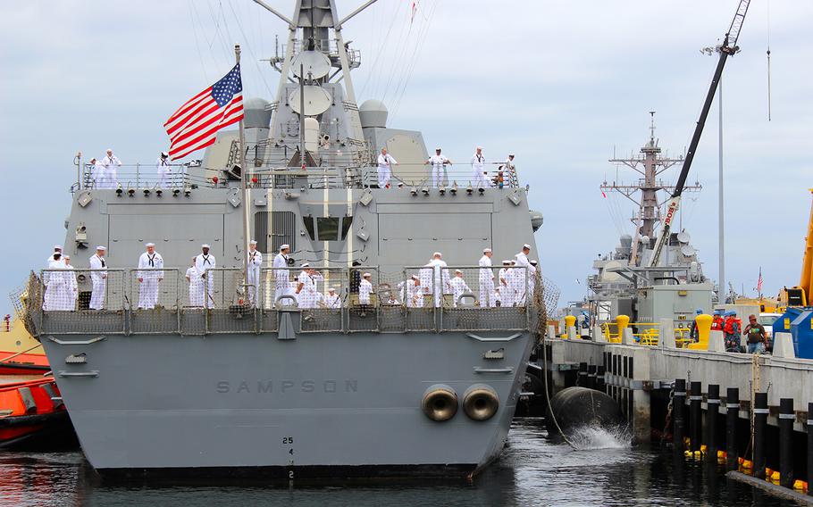 Crew members untie the USS Sampson, a guided-missile destroyer, from the pier as the ship leaves Naval Station San Diego on Friday, Oct. 31, 2014, for a deployment to the western Pacific.