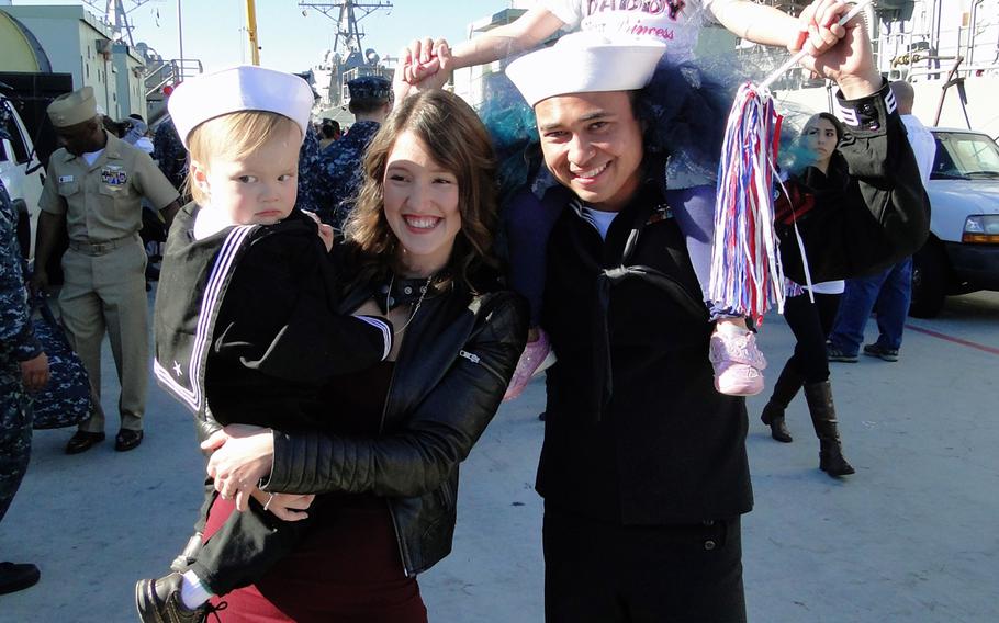 Jenny Brobst and Petty Officer 1st Class Walter Brobst pose with their children, 2-year-old Oliver and 3-year-old Abigail, on Friday, Jan. 16, 2015, at Naval Base San Diego. Brobst was 1 of about 350 sailors who returned home Friday morning after a 7-month deployment aboard the USS Cape St. George.