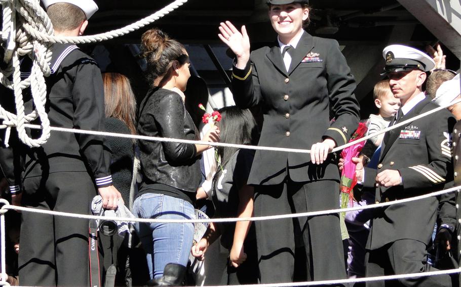 A sailor waves to her family and friends on the pier Friday, Jan. 16, 2015, at Naval Base San Diego. The USS Cape St. George returned Friday morning from a 7-month deployment to the western Pacific Ocean.