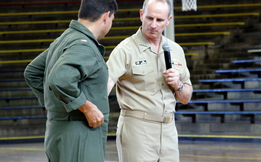 Navy Chief of Naval Operations Adm. Jonathan Greenert explains a new concept for Navy coveralls during an all-hands call at Joint Base Pearl Harbor-Hickam in Honolulu on Friday, Feb. 6, 2015. He enlisted an aviator from the audience to help him with the presentation.