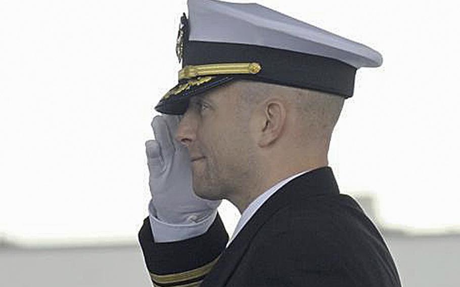 Cmdr. Edward Byers salutes during a ceremony in Groton, Conn., on Nov. 14, 2014, as he assumed command of the USS Dallas submarine. The Navy fired Byers on Tuesday, Feb. 2, 2016, citing a loss of confidence in his ability to lead. 