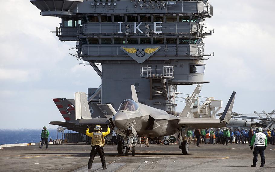 Two test pilots taxi their F-35C Lightning II aircraft aboard USS Dwight D. Eisenhower during the F-35's second developmental test phase somewhere in the Atlantic Ocean on Oct. 2, 2015.
