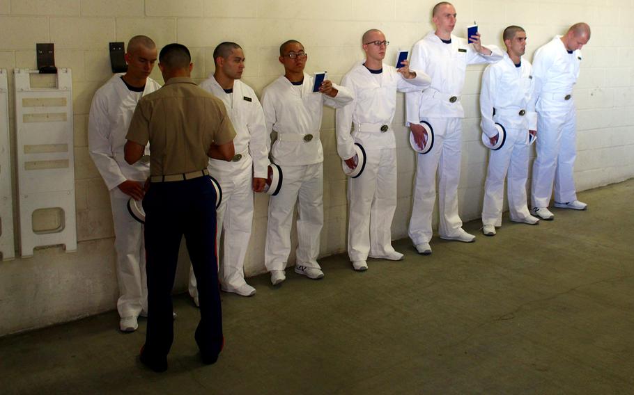 Naval Academy plebes begin to memorize items in an introduction manual handed out to all incoming freshman as a part of Induction Day on Thursday, June 30, 2016.