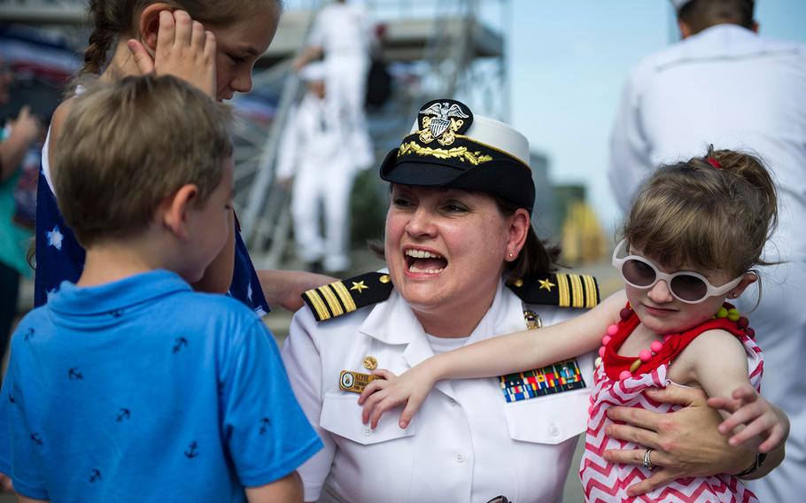 Cmdr. Alysa L. Ambrose Mansfield, commanding officer of the Arleigh Burke-class guided-missile destroyer USS Gravely, greets her family during a homecoming celebration at Naval Station Norfolk on July 13, 2016.
