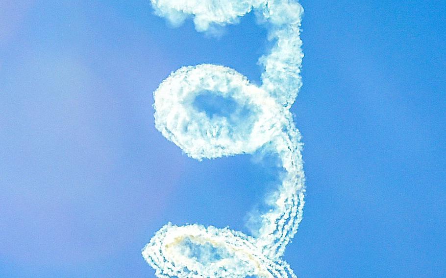Petty Officer 1st Class Remington Peters, a member of the U.S. Navy Parachute Team, the Leap Frogs, performs a hanging smoke during a demonstration at the Dayton Air Show on June 19, 2016.