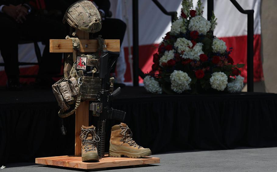 A battlefield cross is displayed in honor of Petty Officer 1st Class (SEAL) Remington Peters during a memorial ceremony at Naval Amphibious Base, Coronado on June 2, 2017.