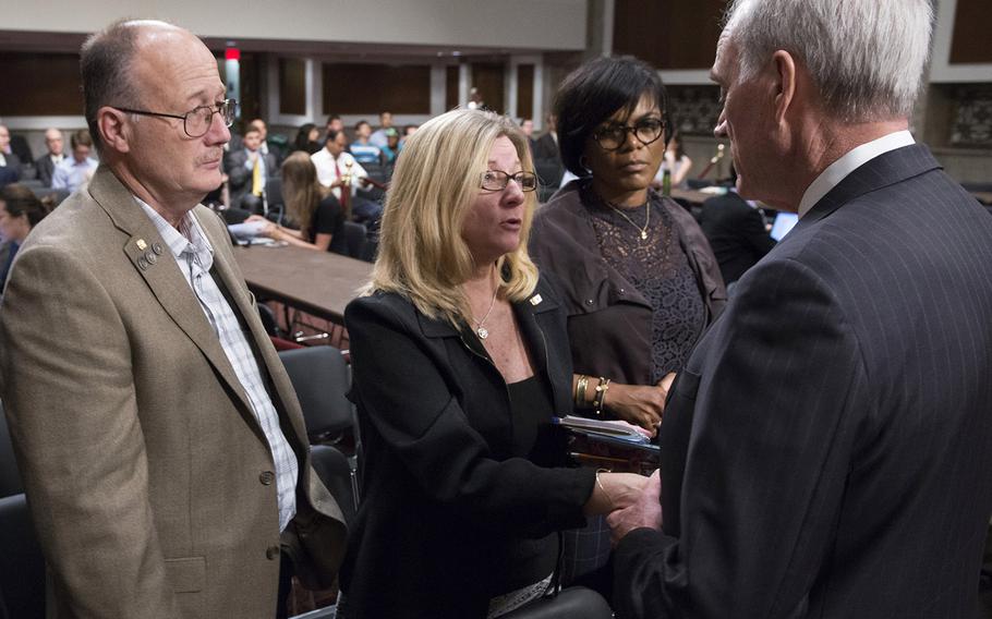 Secretary of the Navy Richard V. Spencer, right, talks with Theresa Palmer, mother of Petty Officer 3rd Class Logan Palmer, before a Senate Armed Services Committee hearing on Capitol Hill, Sept. 19, 2017. At left is Sid Palmer, the father of the sailor who died in a collision between the USS John McCain and a tanker near Singapore on August 21. In the background is Rachel Eckels, whose son, Petty Officer 2nd Class Timothy Thomas Eckels Jr., also died on the McCain.