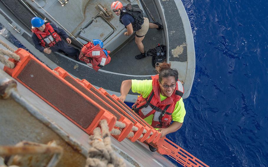 Tasha Fuiaba, an American mariner who had been sailing for five months on a damaged sailboat, climbs the accommodation ladder to board the amphibious dock landing ship USS Ashland on Oct. 25, 2017.